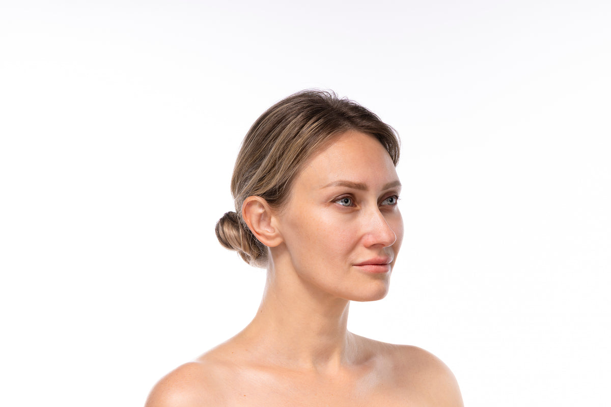 Elena in a calm side-profile portrait representing Quellor’s daily wellness philosophy