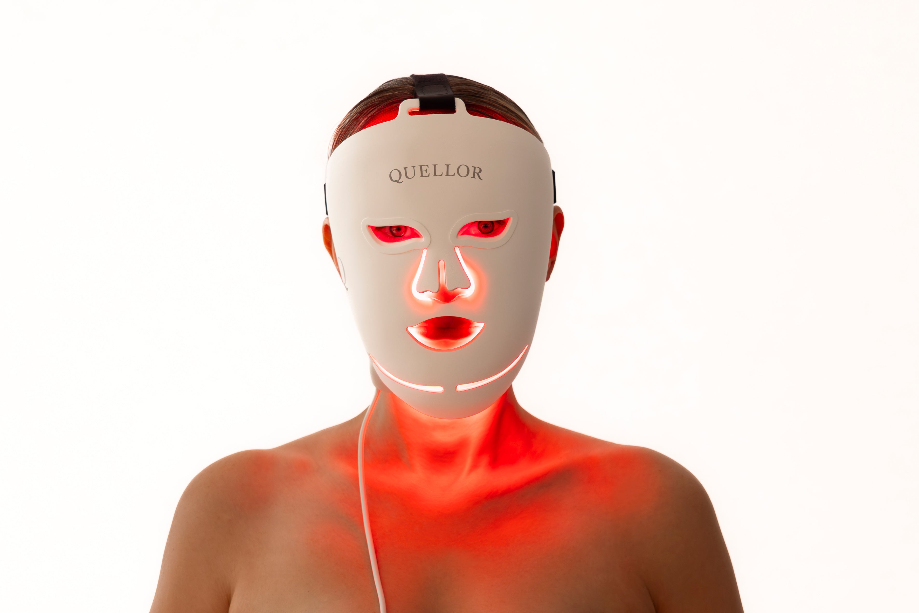 Woman wearing the illuminated Quellor LED Light Therapy Mask.